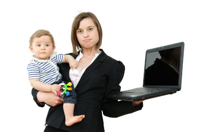 Working mother holding baby and laptop